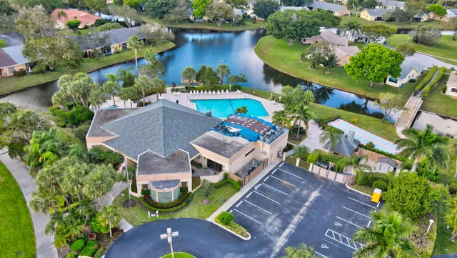 an aerial view of a house with a garden and lake view