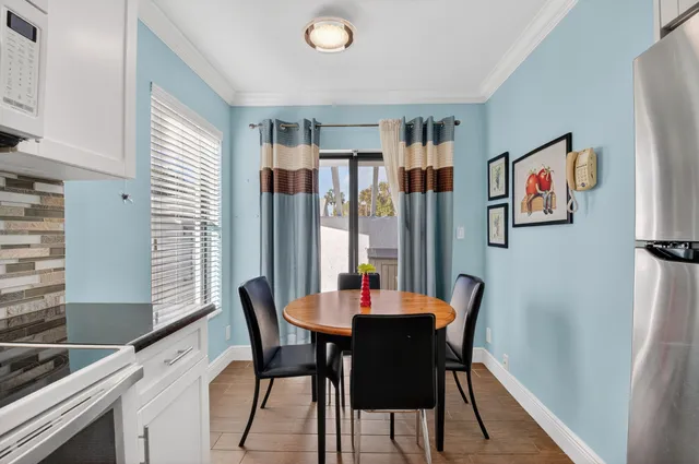 a dining room with furniture and window