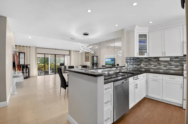 a kitchen with stainless steel appliances granite countertop a sink and cabinets