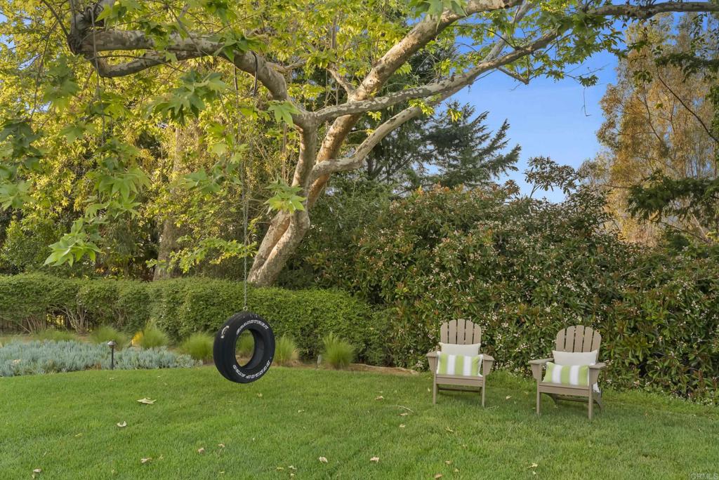 7891 Muirfield Way Rancho Santa Fe, CA 92067 - Photo 16 of 26 a view of a table and chairs in the garden