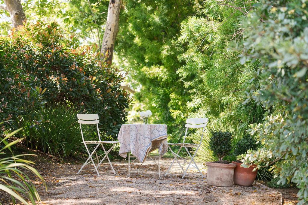 7891 Muirfield Way Rancho Santa Fe, CA 92067 - Photo 17 of 26 a wooden bench sitting in backside of a house