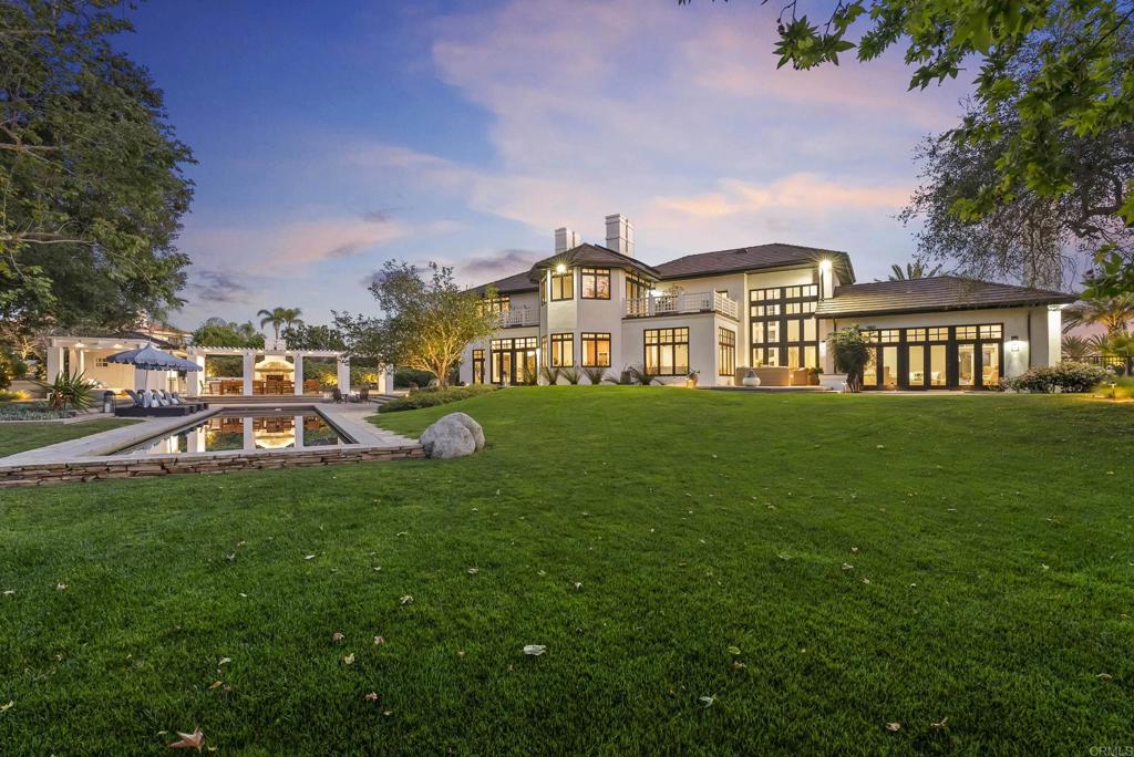 7891 Muirfield Way Rancho Santa Fe, CA 92067 - Photo 25 of 26 a view of a house with a big yard and large trees