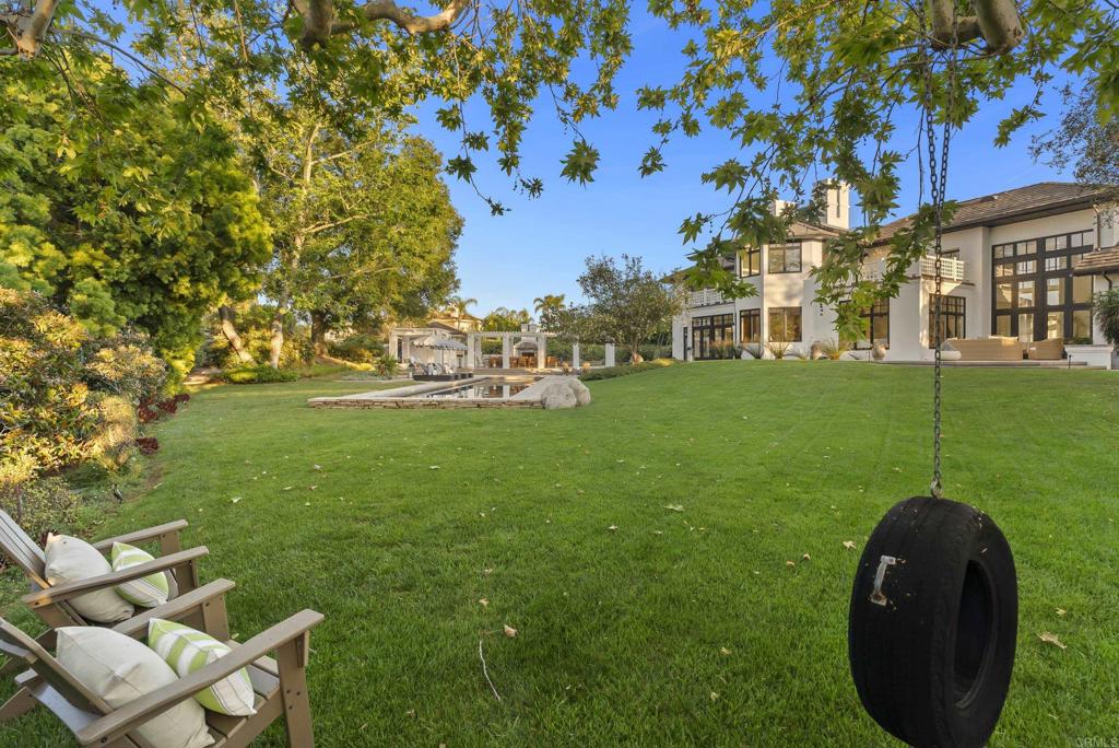 7891 Muirfield Way Rancho Santa Fe, CA 92067 - Photo 26 of 26 a view of yard with swimming pool and green space