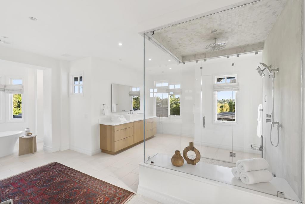 7891 Muirfield Way Rancho Santa Fe, CA 92067 - Photo 9 of 26 a spacious bathroom with a tub sink and mirror