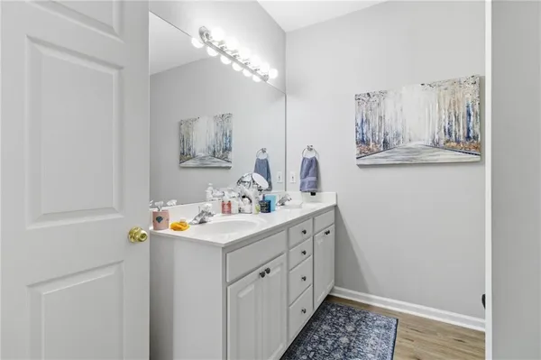 a bathroom with a sink mirror and vanity