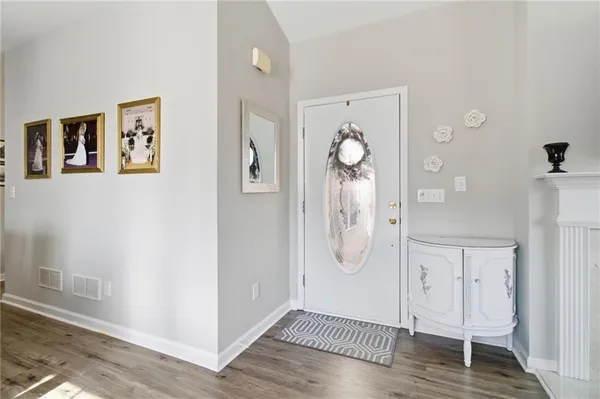 an empty room with wooden floor and mirror