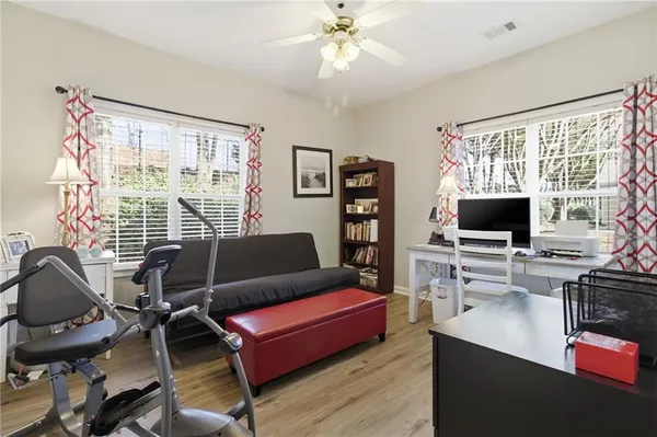 a living room with furniture a flat screen tv and a floor to ceiling window