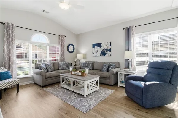 a living room with furniture and a large window