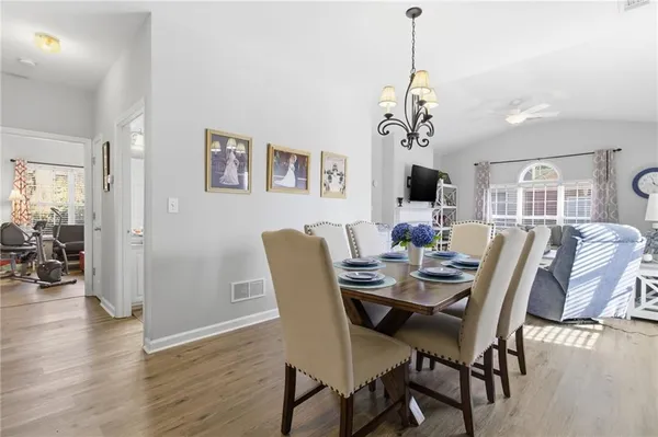 a view of a dining room with furniture wooden floor and chandelier