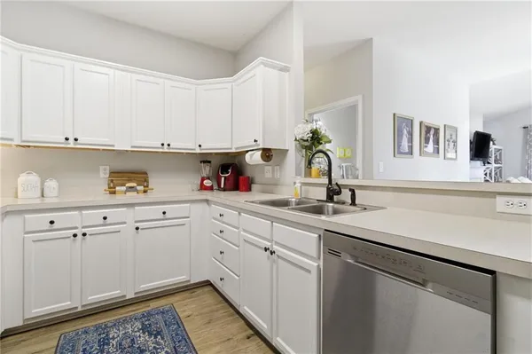 a kitchen with granite countertop white cabinets and white appliances