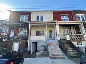 a front view of a building with sitting area