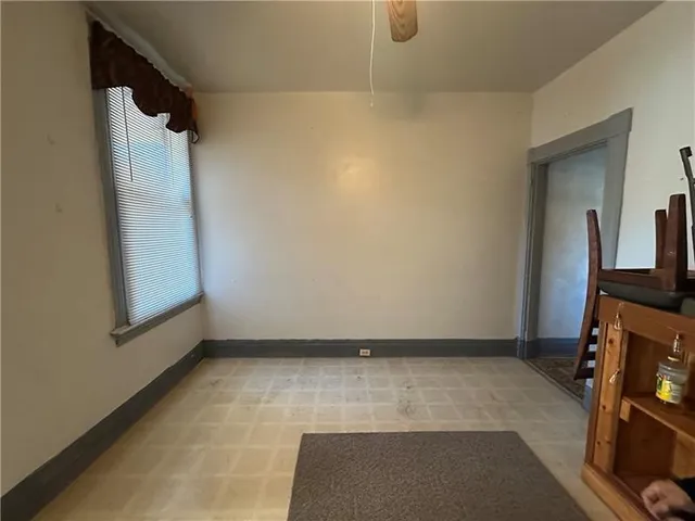 a bedroom with a bed and a refrigerator