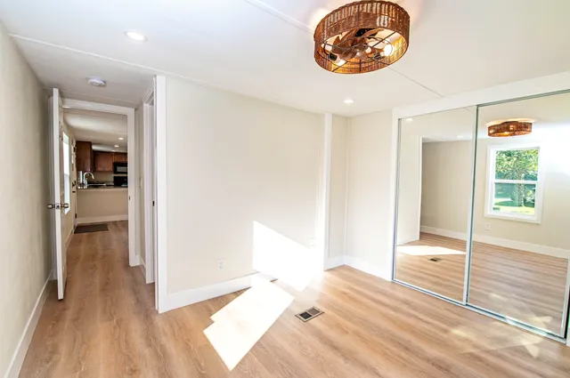 a view of a room with wooden floor
