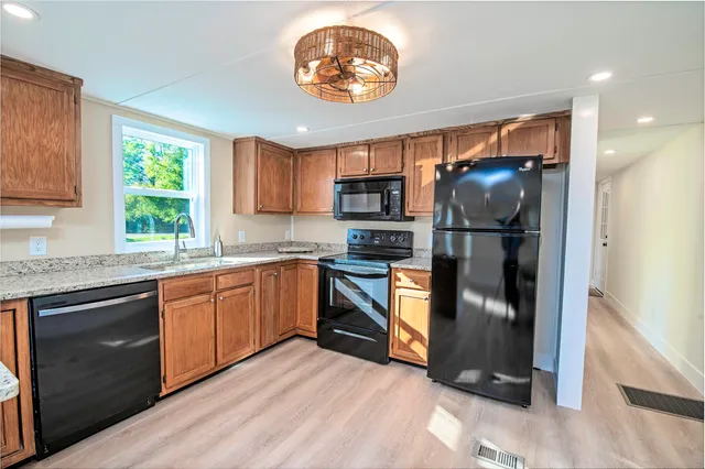 a kitchen with a refrigerator and a stove top oven