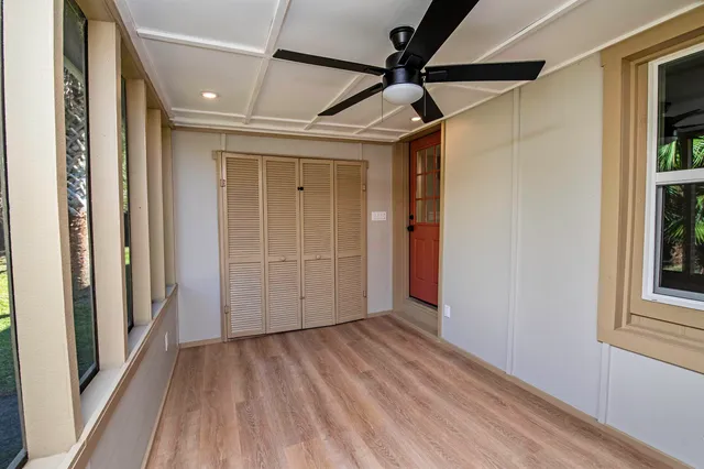 a view of hallway with wooden floor