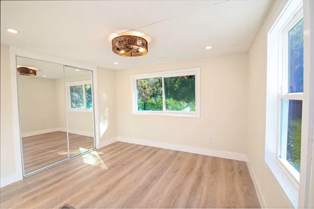 wooden floor in an empty room with a window