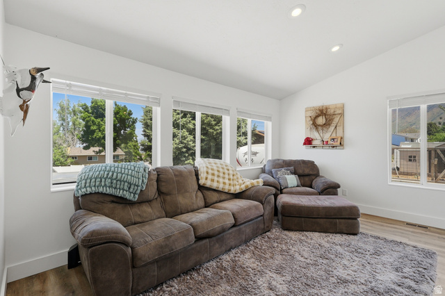 114 North Clark Lane Elk Ridge, UT 84651 - Photo 8 of 26 Bright interior space featuring multiple large windows, recessed ceiling lighting, and wood-finish flooring