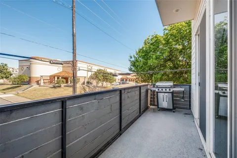 a kitchen with stainless steel appliances granite countertop a refrigerator a sink a stove and a wooden floors
