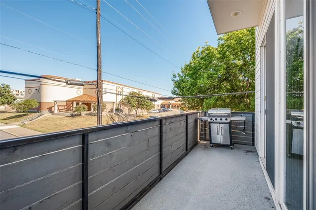 a kitchen with stainless steel appliances granite countertop a refrigerator a sink a stove and a wooden floors