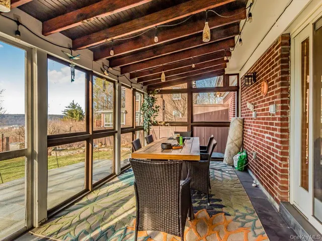 a dining room with furniture water view and wooden floor