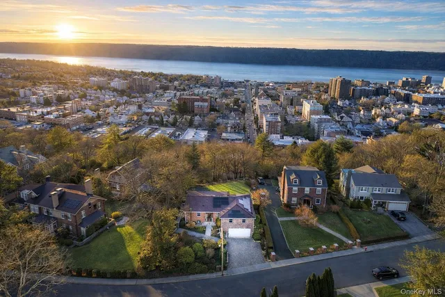 an aerial view of residential houses with outdoor space and swimming pool