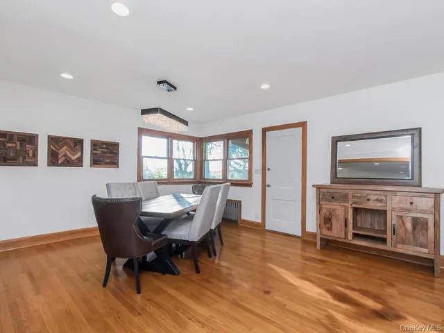 a dining room with furniture a fireplace and wooden floor