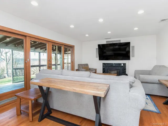 a view of living room filled with furniture and a flat screen tv