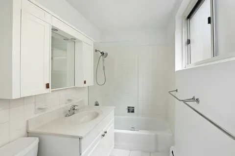 a bathroom with a sink toilet tub and shower