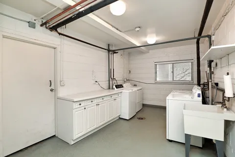 a kitchen with sink and white cabinets