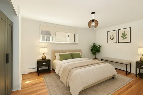 a bedroom with a bed and painting on the wall