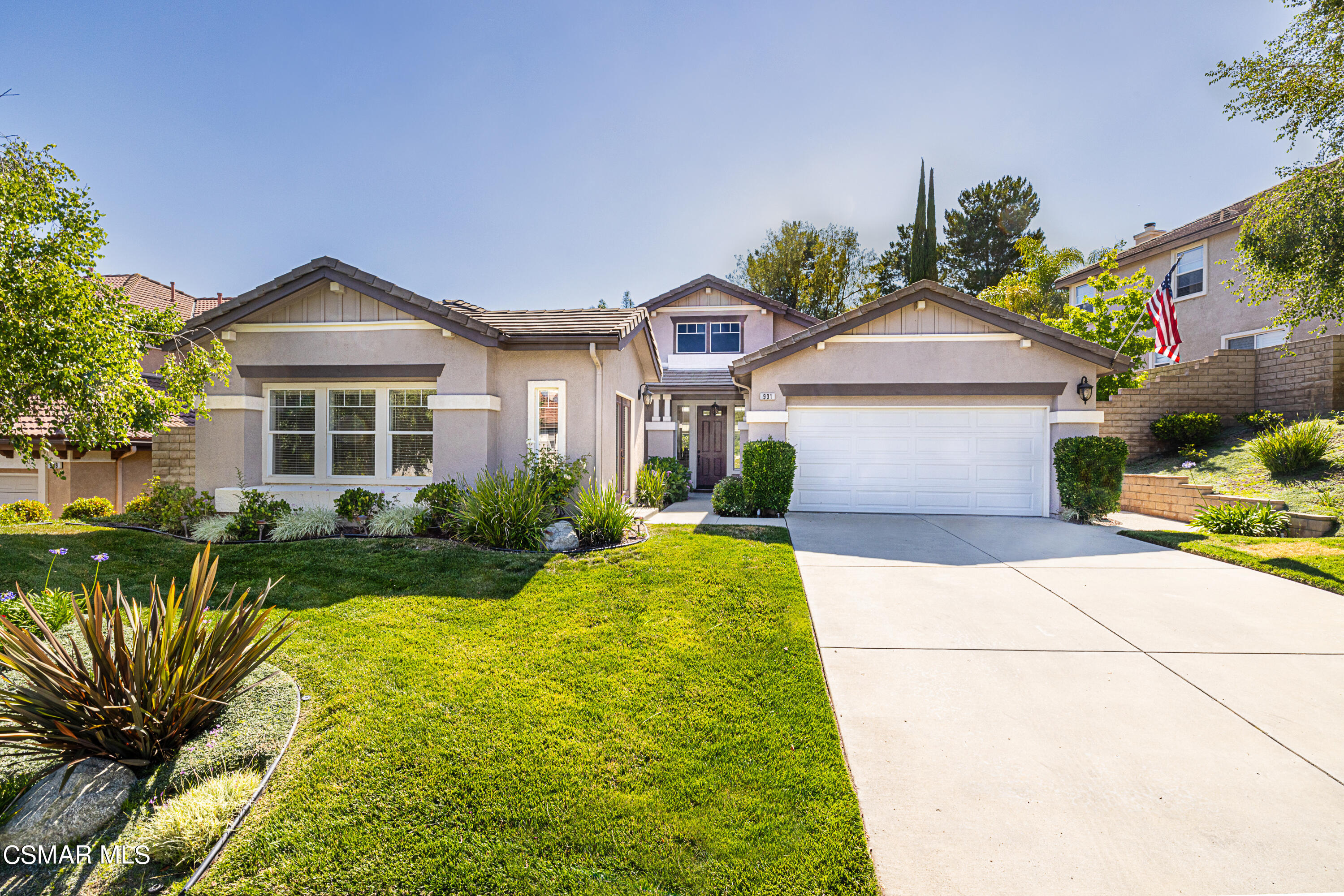 931 North Wood Ranch Parkway Simi Valley, CA 93065 - Photo 2 of 33 a front view of a house with a garden and plants