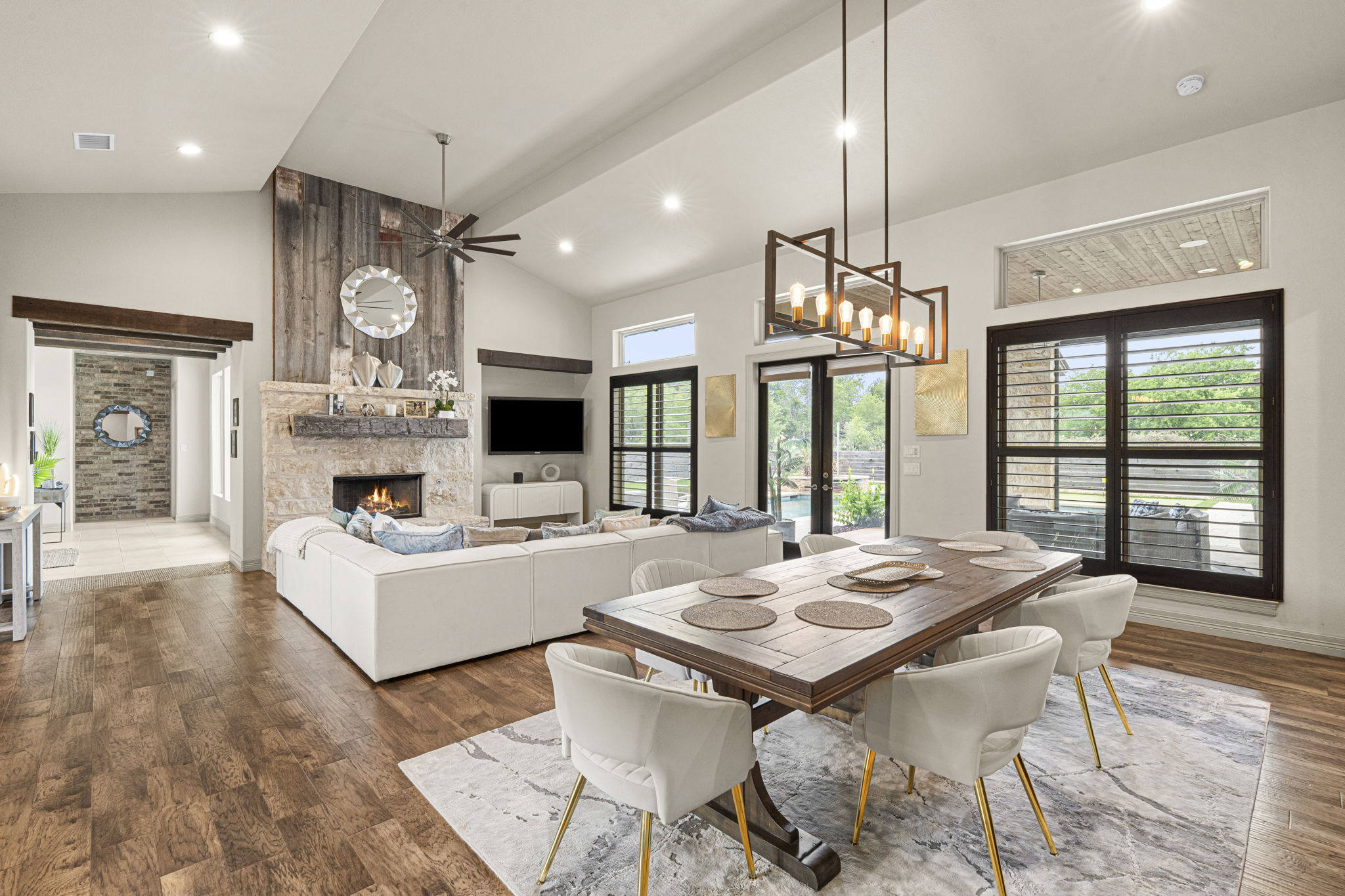 16202 Remuda Trail Buda, TX 78610 - Photo 6 of 40 The interior features hardwood flooring, a fireplace with a stone surround, and vaulted ceilings with recessed lighting