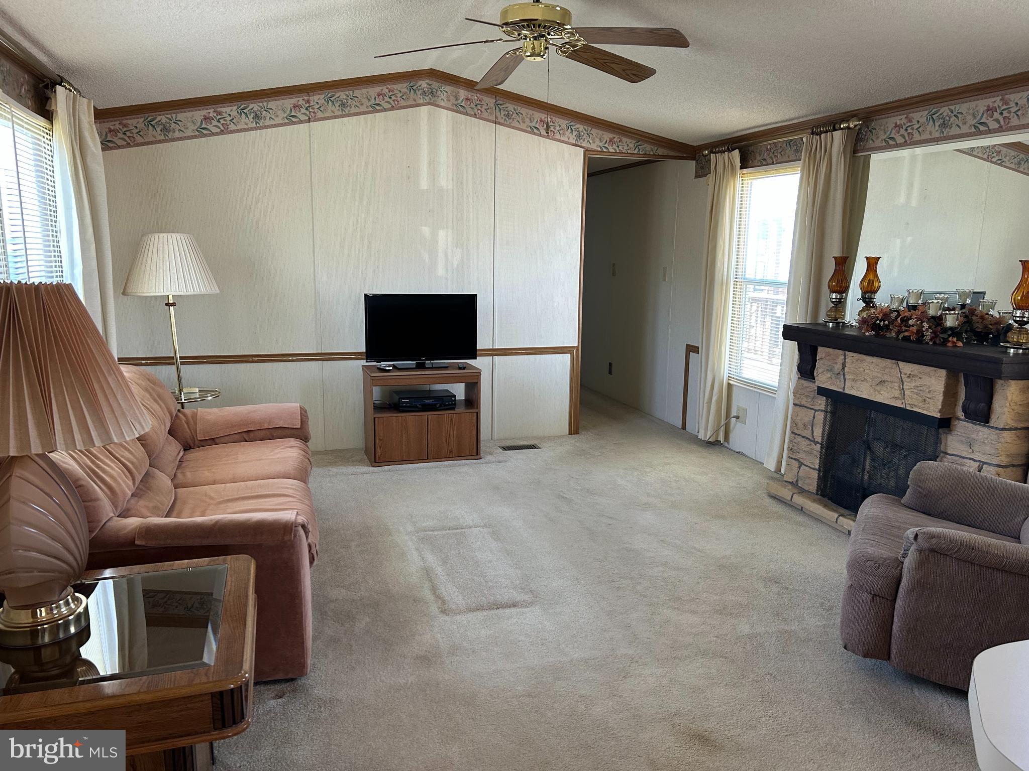 34 Winterset Road, Unit 11 Wilmington, DE 19810 - Photo 11 of 26 a living room with furniture and a flat screen tv