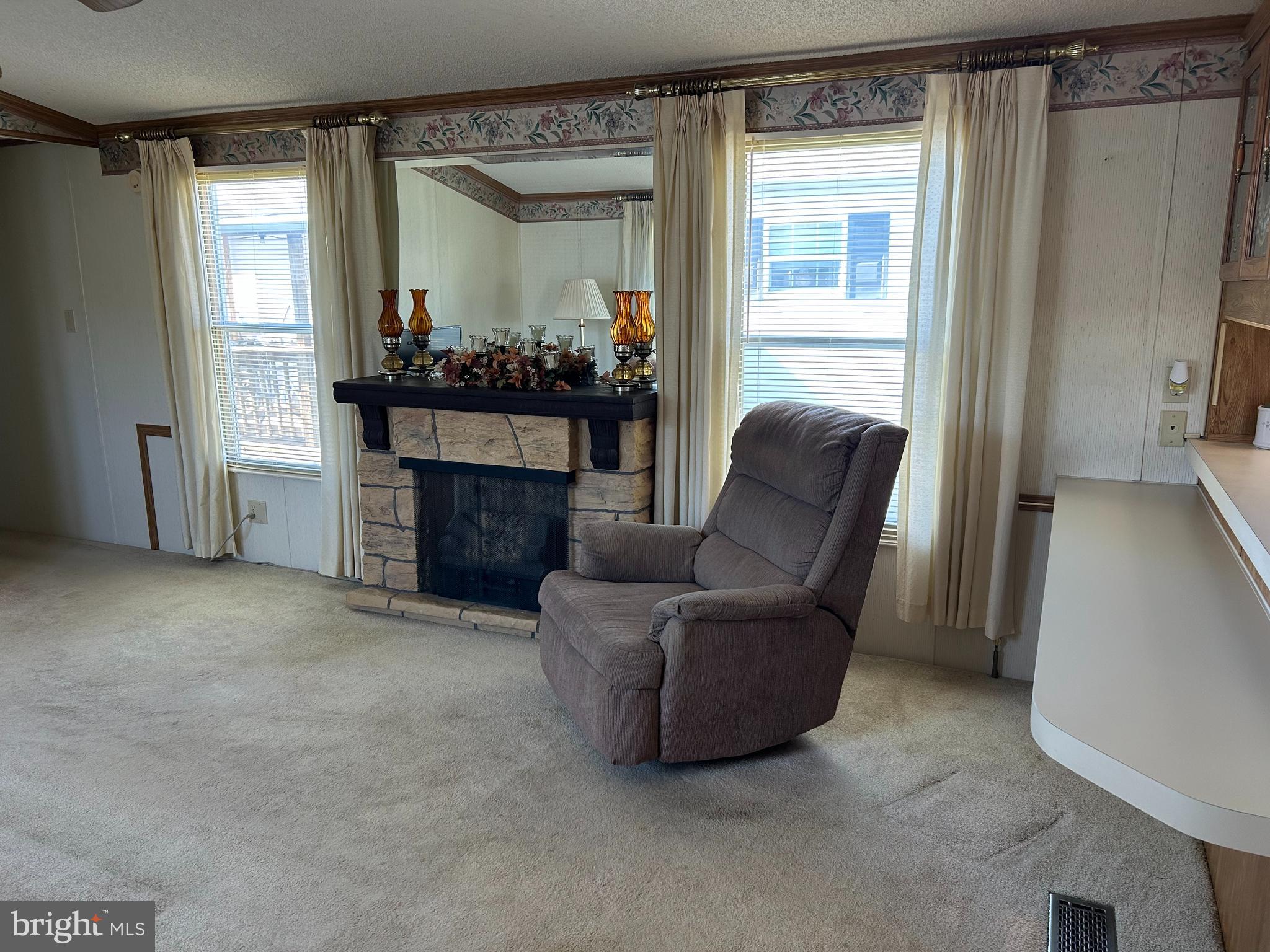 34 Winterset Road, Unit 11 Wilmington, DE 19810 - Photo 12 of 26 a living room with furniture and a fireplace