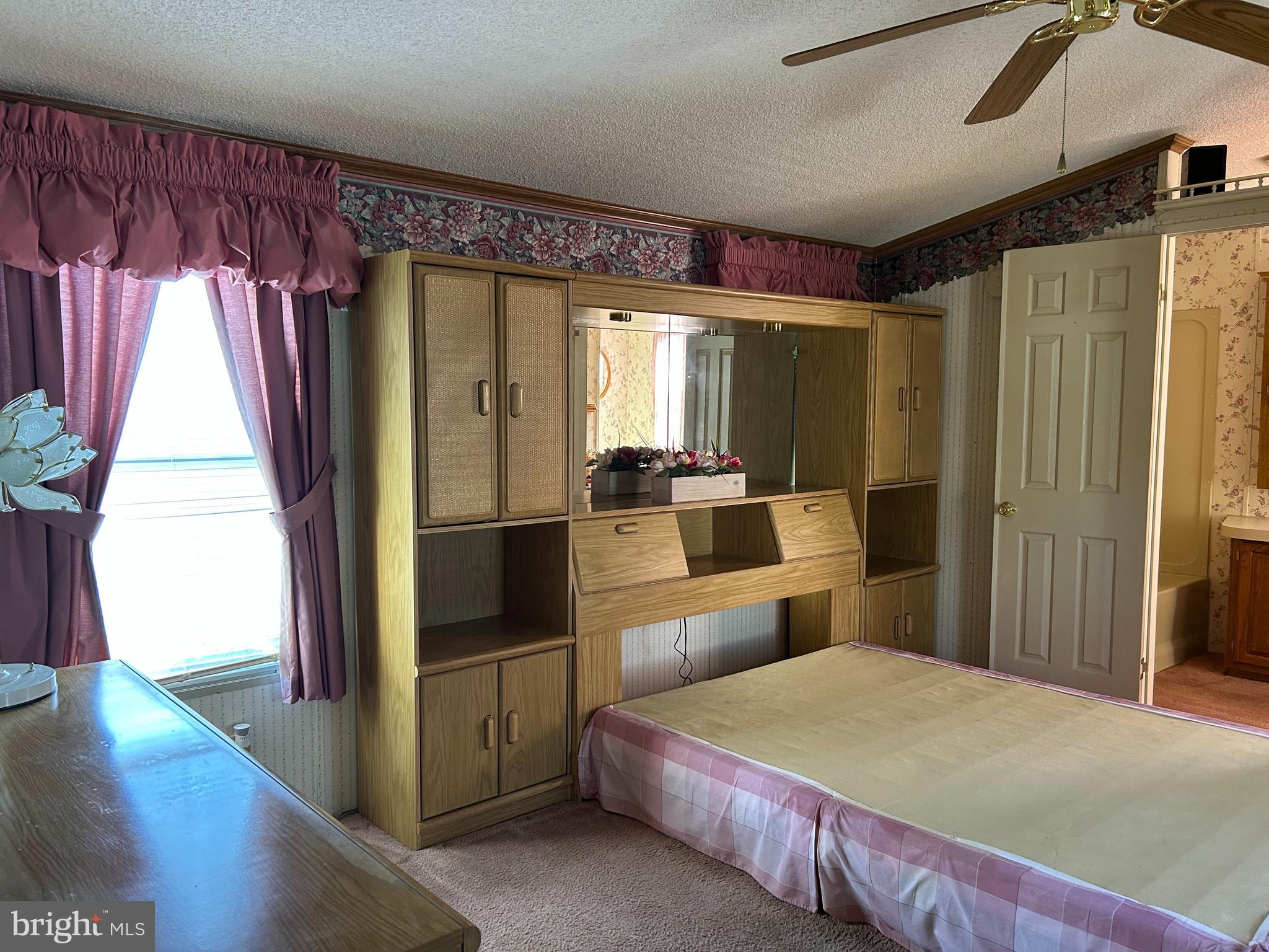 34 Winterset Road, Unit 11 Wilmington, DE 19810 - Photo 15 of 26 a bedroom with a bed and a view of bathroom