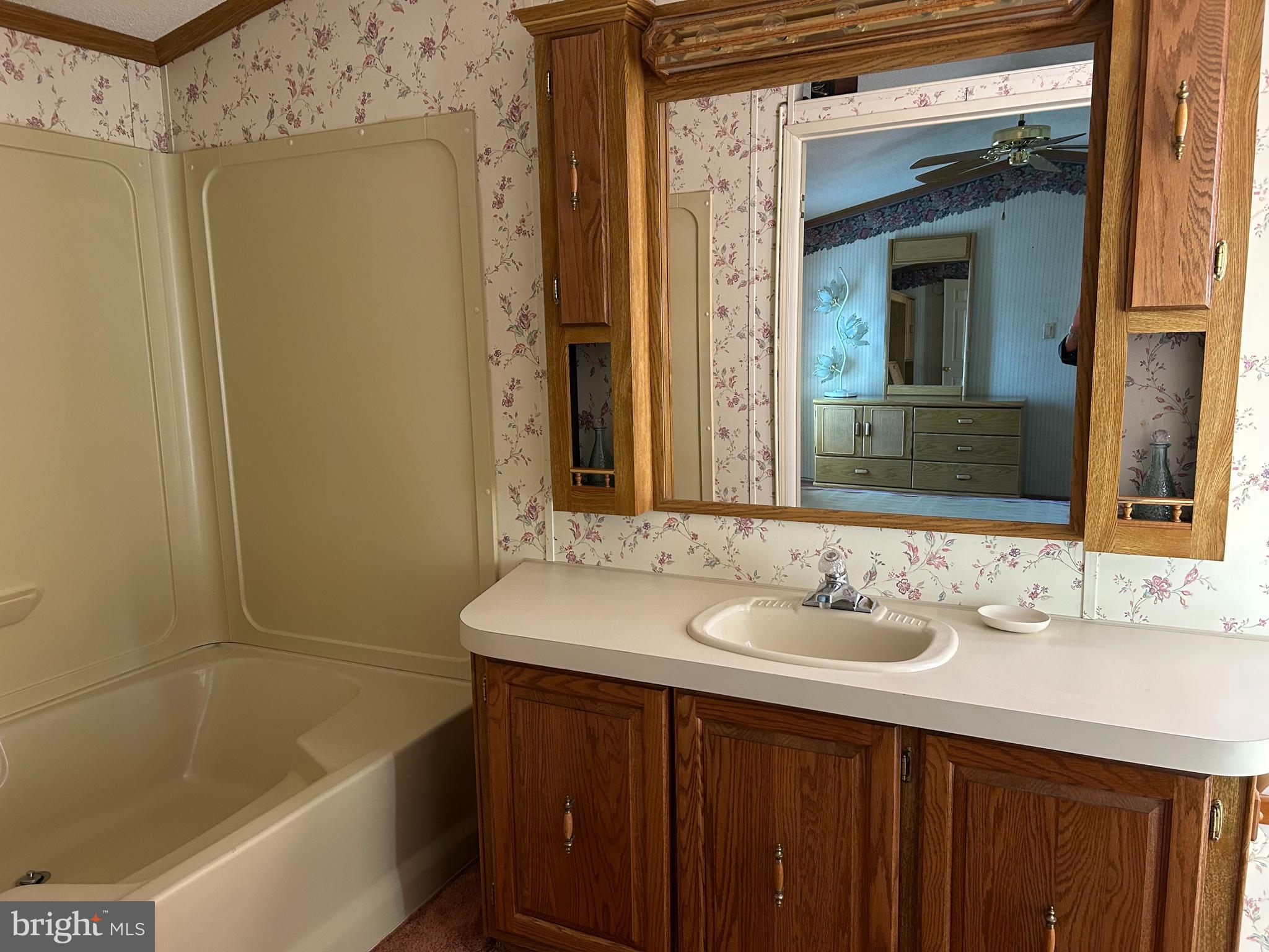 34 Winterset Road, Unit 11 Wilmington, DE 19810 - Photo 16 of 26 a bathroom with a sink a mirror and a bathtub