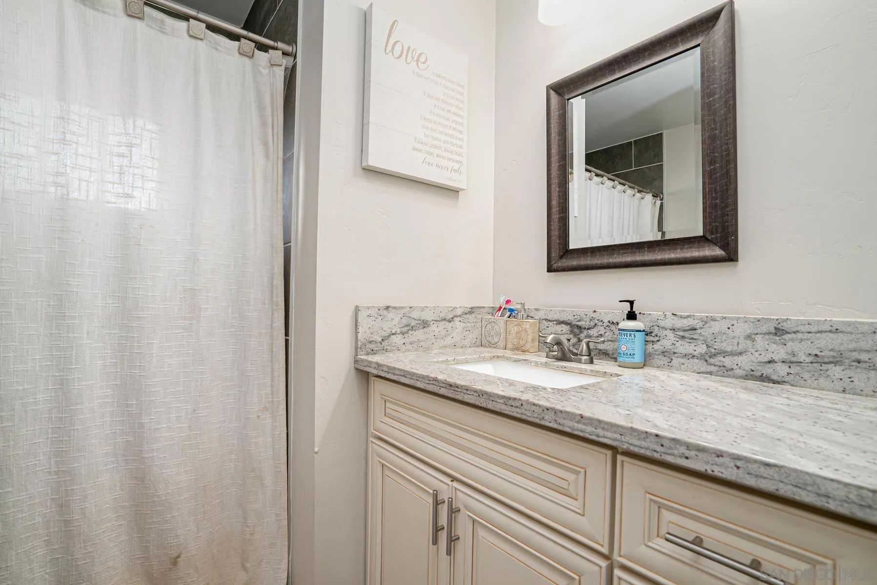 8531 Gardena Road Lakeside, CA 92040 - Photo 5 of 29 a bathroom with a granite countertop sink and a mirror