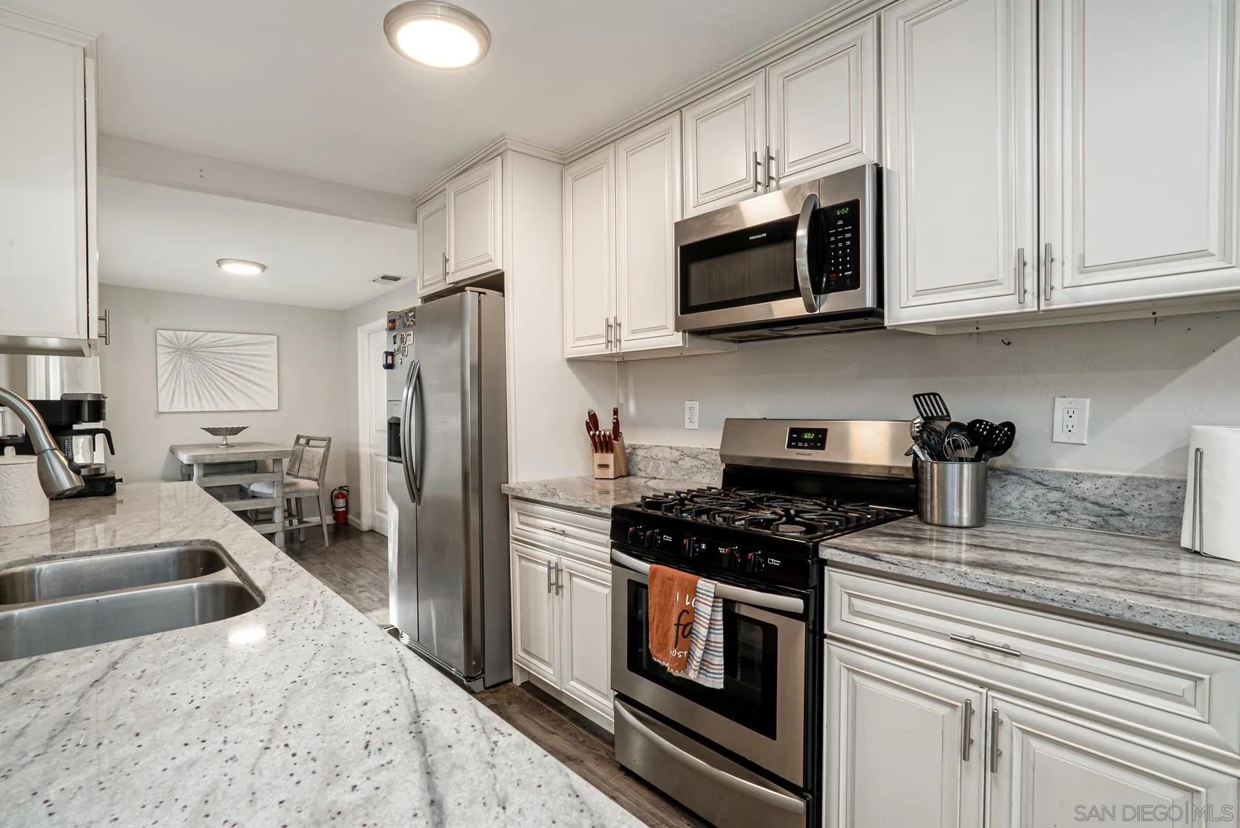 8531 Gardena Road Lakeside, CA 92040 - Photo 10 of 29 a kitchen with stainless steel appliances granite countertop a stove a refrigerator and a microwave