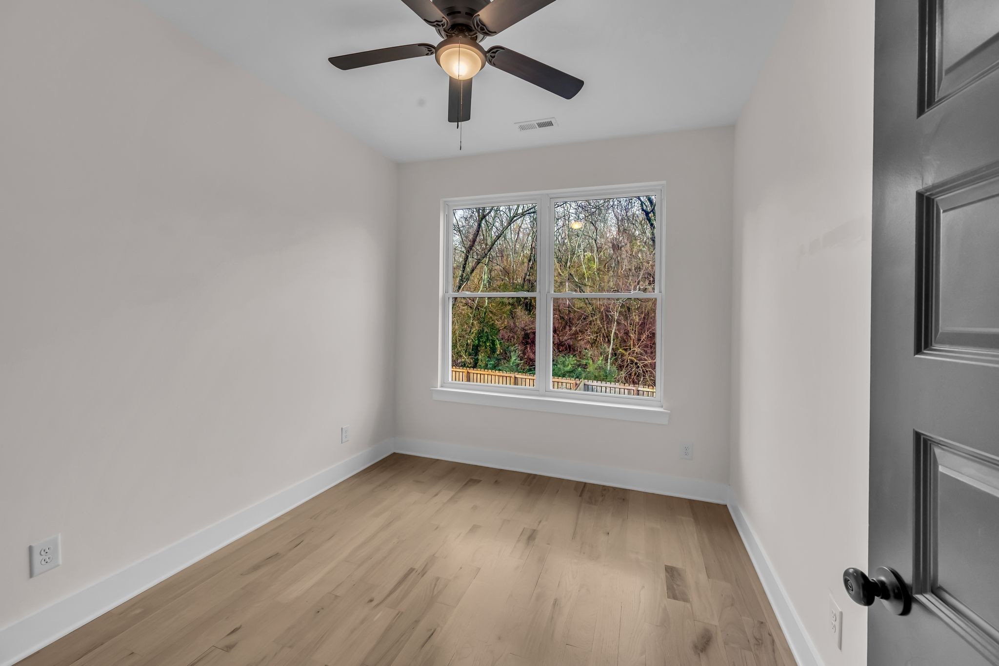 425 Toney Road, Unit B Nashville, TN 37207 - Photo 11 of 14 an empty room with wooden floor chandelier fan and windows