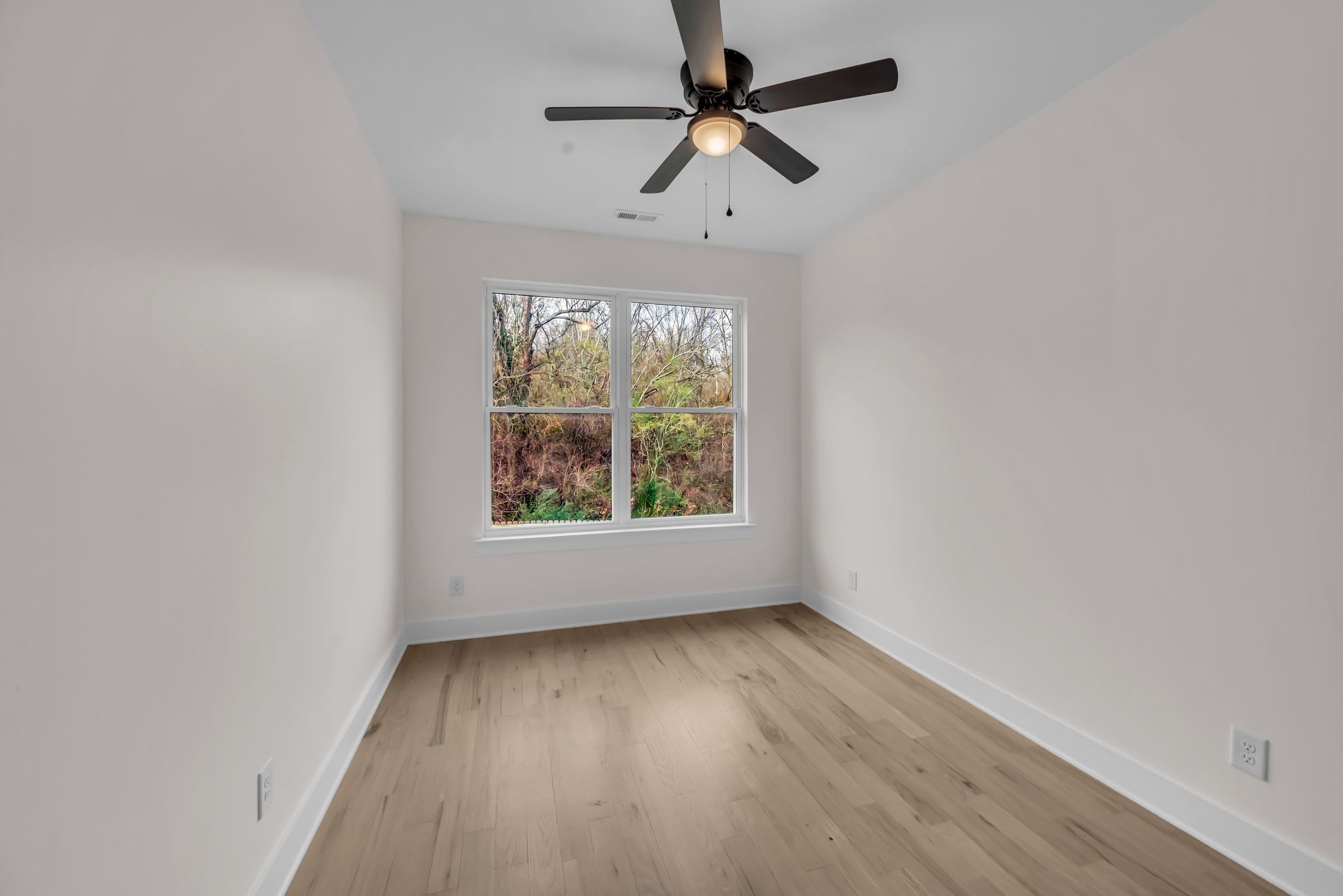 425 Toney Road, Unit B Nashville, TN 37207 - Photo 12 of 14 an empty room with wooden floor fan and windows