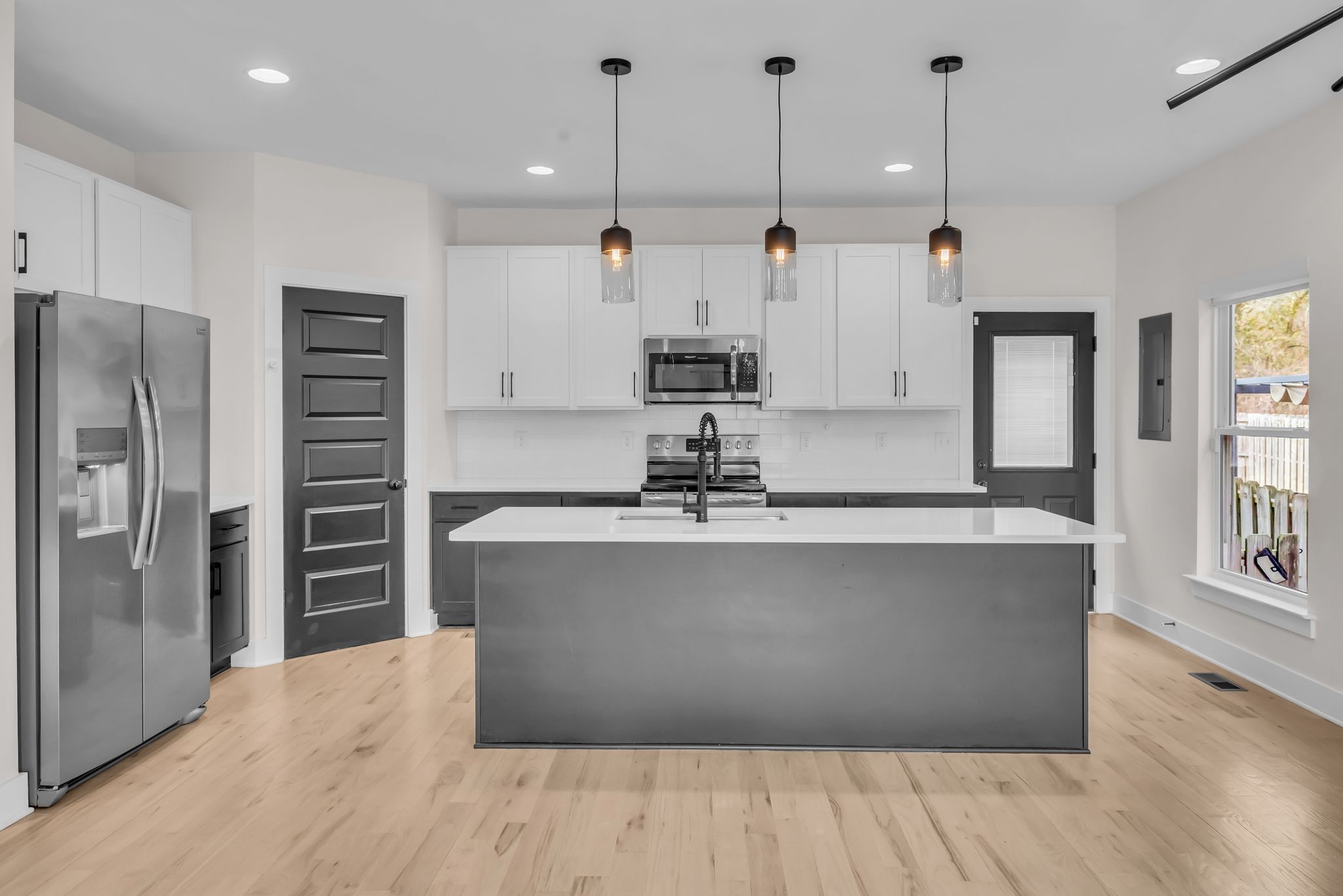425 Toney Road, Unit B Nashville, TN 37207 - Photo 4 of 14 a view of kitchen with stainless steel appliances kitchen island wooden floors and living room view