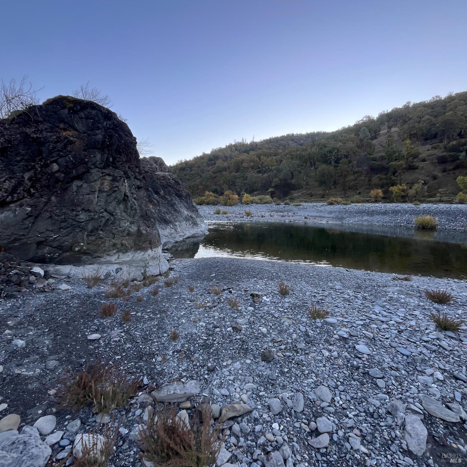 31975 Mendocino Pass Road Covelo, CA 95428 - Photo 2 of 23 a view of a lake with a mountain in the background
