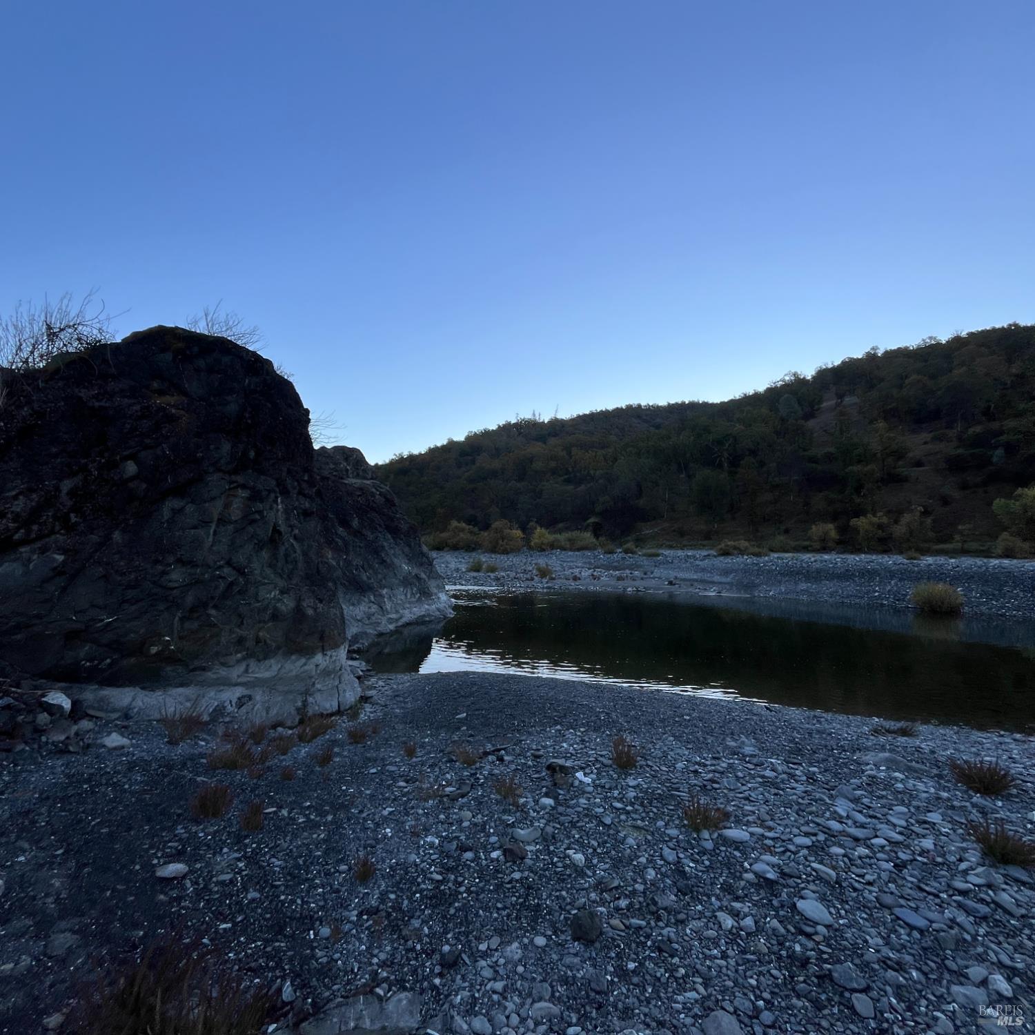 31975 Mendocino Pass Road Covelo, CA 95428 - Photo 5 of 23 a view of a lake with a mountain in the background