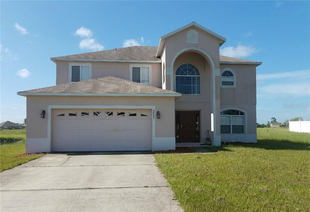 2093 Rio Grande Canyon Loop Poinciana, FL 34759 - Photo 1 of 1 a view of a house with a garden and entryway