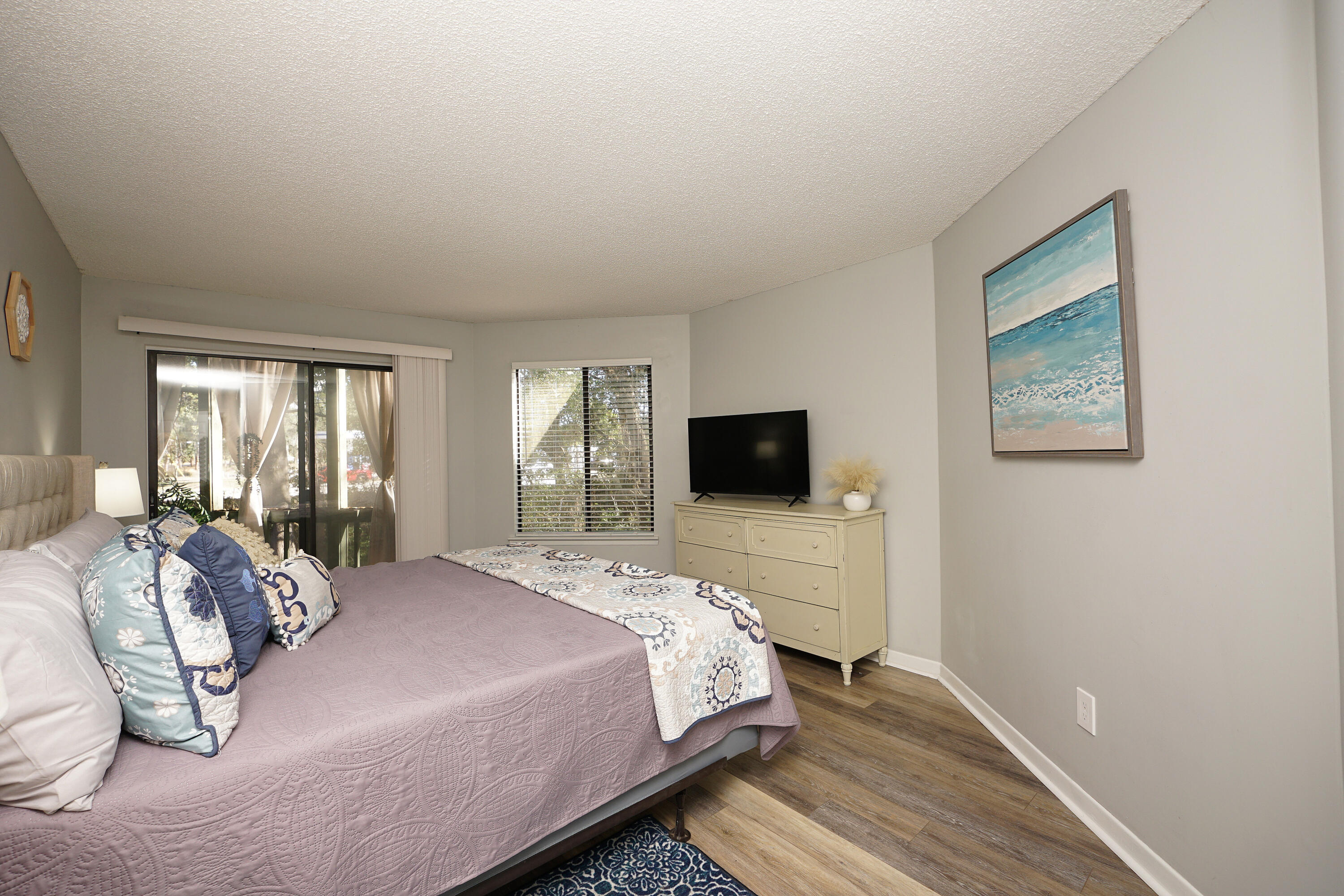 55 Bay Drive, Unit 2202 Niceville, FL 32578 - Photo 19 of 29 a bedroom with a bed and a flat screen tv
