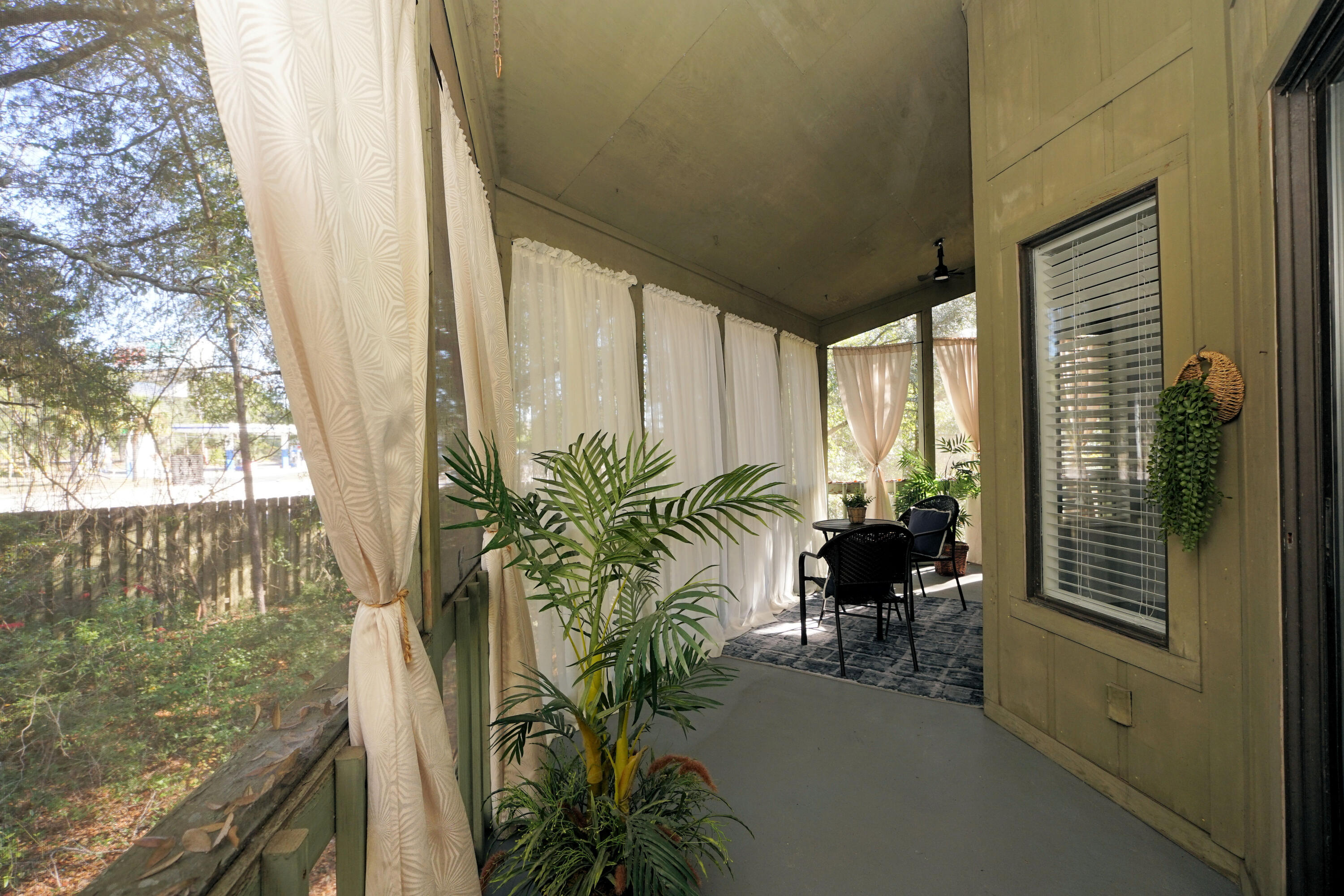 55 Bay Drive, Unit 2202 Niceville, FL 32578 - Photo 26 of 29 a view of a porch with chairs and backyard