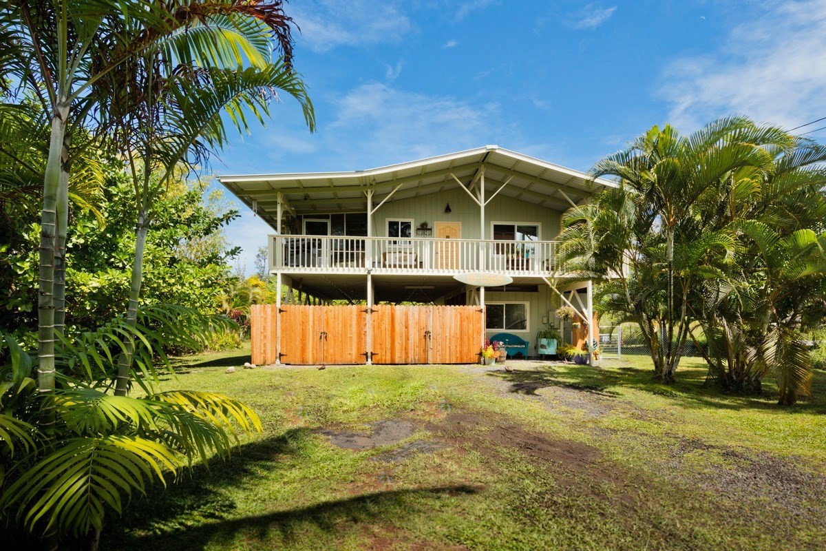 15-1565 Beach Road Keaau, HI 96749 - Photo 1 of 27 a front view of a house with a garden