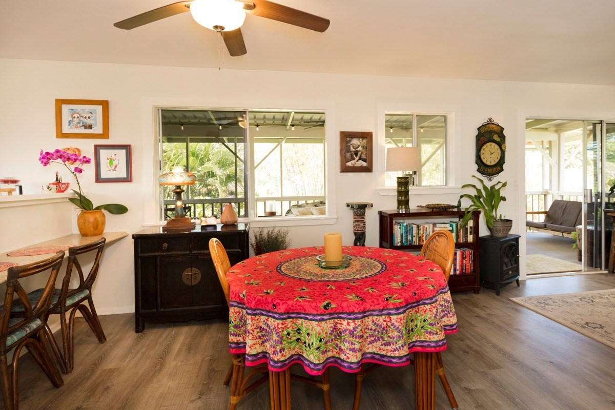 15-1565 Beach Road Keaau, HI 96749 - Photo 15 of 27 a view of a dining room with furniture window and wooden floor