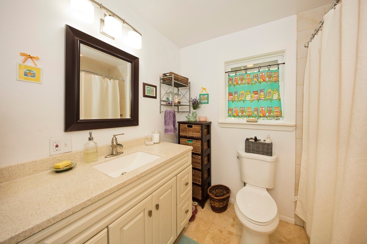 15-1565 Beach Road Keaau, HI 96749 - Photo 19 of 27 a bathroom with a toilet a sink and a mirror