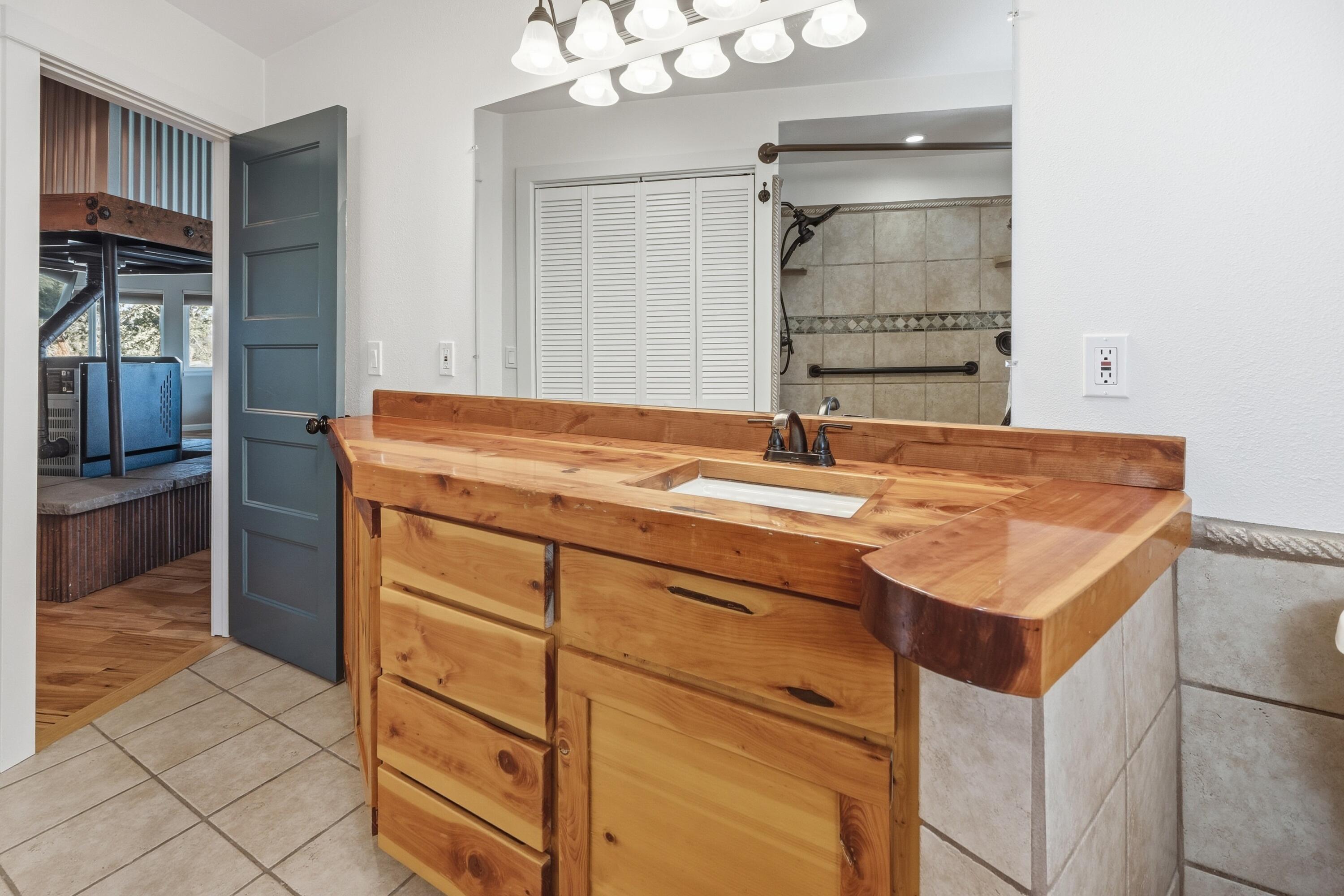 4074 Southwest Reif Road Powell Butte, OR 97753 - Photo 24 of 59 a bathroom with a sink vanity granite and a mirror